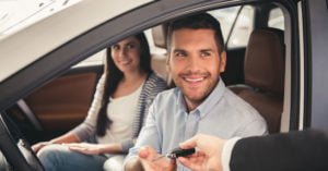 Young couple in their new car
