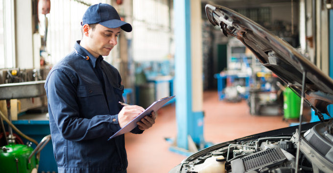 car mechanic writing an estimate